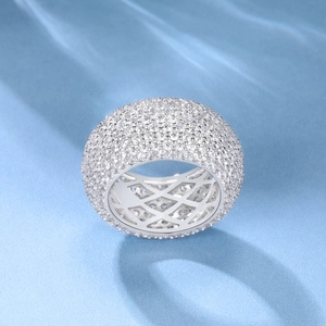 18k gold plated Cuban pave ring with rows of clear zircon on a light blue water ripple background