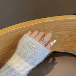 Detail of silver 925 ring featuring irregular wrinkled texture on a model's finger