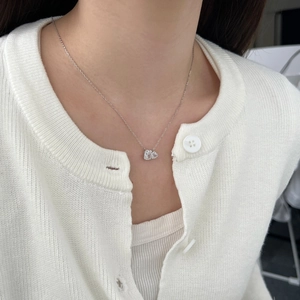 Close-up of S925 silver necklace with geometric crystal pendant on model's neck