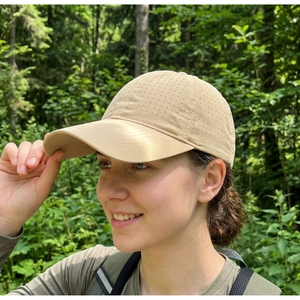 Close-up of beige quick-dry mesh baseball cap with breathable holes for outdoor sports
