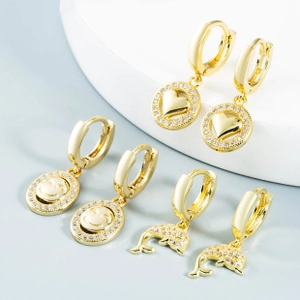 Detailed view of three pairs of gold-plated hoop earrings featuring heart and dolphin charms