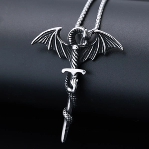 Detailed macro view of a vintage silver dragon coiling around a sword pendant