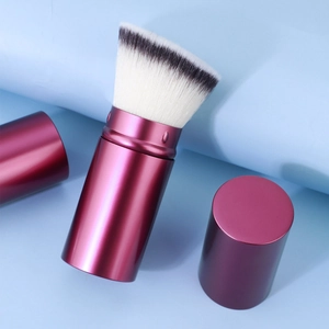 Portable retractable makeup brush with metallic purple handle and soft dual-tone bristles