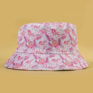 Pink daisy print bucket hat for women with reversible summer sun protection design