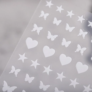3D white butterfly star heart nail stickers with embossed matte texture on gray background