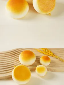 Macro shot of realistic golden-brown soft PU bread toy on a wooden tray with wheat