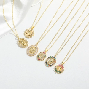 Detailed close-up of gold Virgin Mary pendants with colorful zircon and gemstone inlays