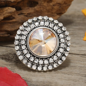 Macro shot of adjustable round ring with champagne crystal and sparkling pave rhinestones
