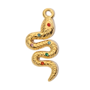 Macro shot of a golden snake pendant with colorful rhinestones and scales texture