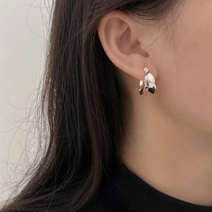 Close-up of minimalist 925 sterling silver U-shaped earring worn on a model's ear