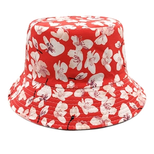 Detail of red floral bucket hat with white flower print and reinforced brim stitching