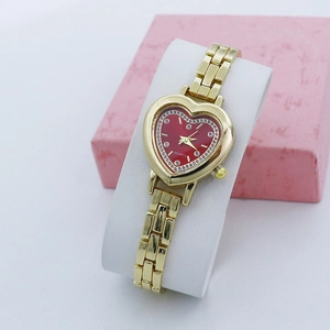 Elegant gold quartz watch for women with a red heart-shaped dial and crystal inlay