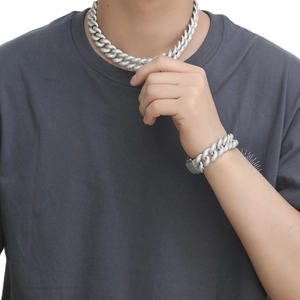 Close-up of 18mm silver Cuban link chain bracelet and necklace set with paved zircons