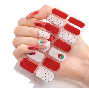 3D laser gold nail stickers with red strawberry and polka dot patterns on a model hand