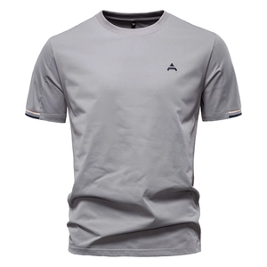 Macro detail of men's grey cotton T-shirt featuring high-quality embroidery and crew neck