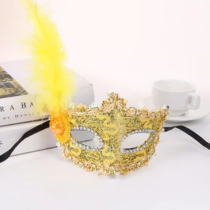 Macro view of carnival lace mask featuring golden feathers and silver sequin details