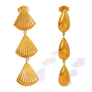 Asymmetric gold teardrop and shell earrings with a layered modern aesthetic design
