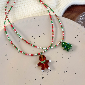 Festive beaded Christmas necklace featuring gingerbread man and Xmas tree pendants