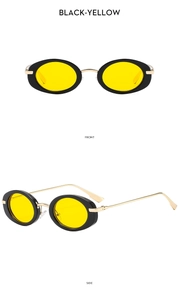 Close-up of retro oval sunglasses with black frames, yellow lenses, and gold temples