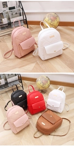 Detailed view of quilted mini backpacks in five colors including pink, white, and black
