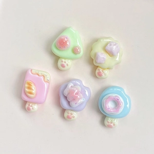 Close-up of assorted glitter resin charms including donuts and ice cream shapes