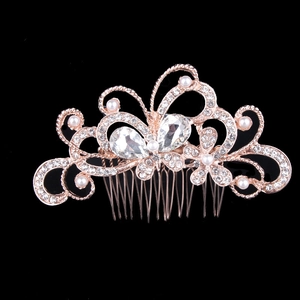 Close-up of rose gold hair comb with rhinestones and pearls in butterfly flower design