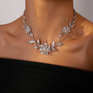 Silver-tone floral leaf necklace with sparkling diamonds and brushed metal texture