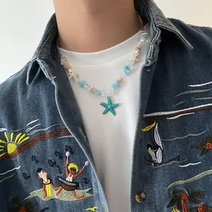 Close-up of a summer sea style necklace with a green starfish pendant and blue beads