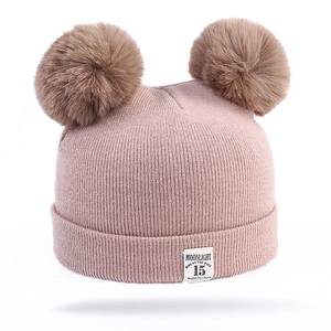Pink knit baby beanie with two large brown faux fur pom poms and soft ribbed texture