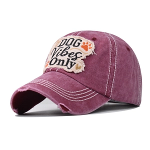 Close-up of distressed cotton baseball cap with DOG Vibes Only embroidery and stitching