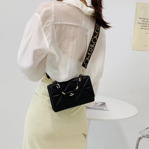 Fashionable black quilted chain crossbody bag with a wide geometric print shoulder strap