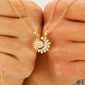 Close-up of interlocking sun and moon necklaces with sparkling zircon inlays