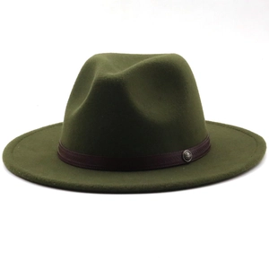 Detail of army green wool fedora hat with a brown decorative band and vintage metal button