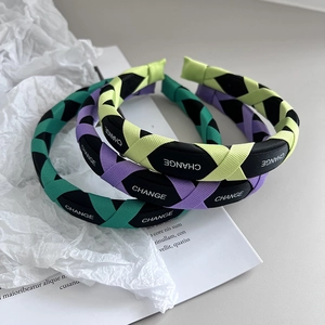 Close-up of woven candy-colored sponge headbands with CHANGE letter print texture