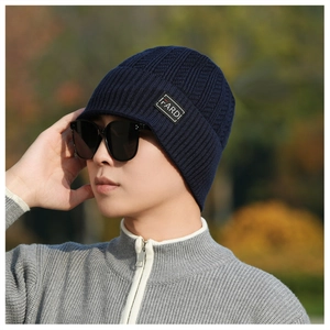 Close-up of winter knit beanie showing deep blue diamond patterns and IFARDI label