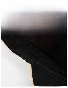 Detail shot of the widened sweatband on a black baseball cap with premium stitching