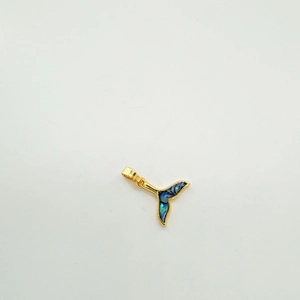 Macro shot of 18K gold-plated whale tail pendant with inlaid blue abalone shell