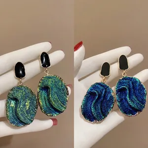 Vintage gold textured resin drop earrings in aurora green and royal blue finish