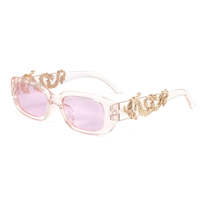 Macro side view of vintage oval sunglasses with pink lenses and gold dragon temple detail