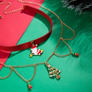 Detail view of velvet Santa choker and Christmas tree necklace on a festive background