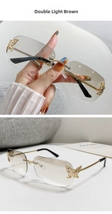Detail view of rimless sunglasses with gold butterfly metal hinge and gradient lenses