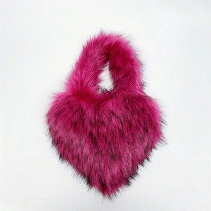 Detail of rose red heart-shaped faux fur bag with black tips and fluffy texture