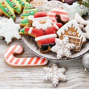 Close-up of festive Christmas cookie cutters featuring Santa, snowflake, and tree shapes
