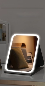 Detail showing tricolor LED light modes and stepless dimming on a foldable makeup mirror