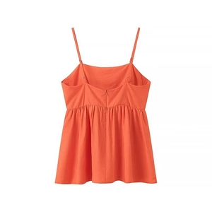 Détail du haut orange avec bretelles réglables, fermeture éclair et texture en coton et lin