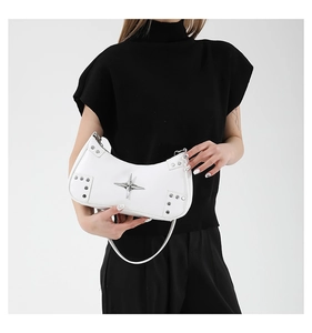 Close-up of white Y2K underarm bag featuring silver star ornament and metallic rivet details