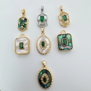 Assorted 18K gold plated pendants with emerald green stones and mother of pearl inserts