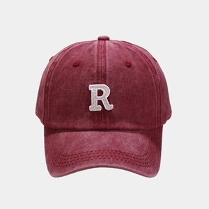 Close-up of the vintage washed red cotton baseball cap with white R letter embroidery