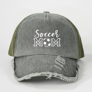 Detail of frayed brim on vintage Soccer MOM trucker hat with grey denim and green mesh