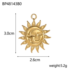 Detail view of gold sun and moon face pendant showing 3.0cm by 2.6cm dimensions